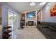 Bright living room boasts a fireplace, flatscreen tv, and sliding glass doors to pool at 13528 Woodside Dr, Hudson, FL 34667
