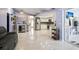 Open-concept living area with bar, kitchen, and access to a sunroom, creating a bright and airy space at 13528 Woodside Dr, Hudson, FL 34667