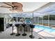 Covered outdoor kitchen area overlooking a refreshing swimming pool at 13528 Woodside Dr, Hudson, FL 34667