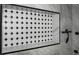 Modern black and white accent tile shower with multi-setting shower system, offering a blend of style and comfort at 13528 Woodside Dr, Hudson, FL 34667