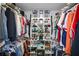 Organized walk-in closet featuring custom shelving for shoes and ample hanging space for clothes at 13528 Woodside Dr, Hudson, FL 34667