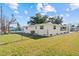 Spacious backyard with a freshly painted exterior and well-maintained landscaping at 1499 Janet Pl, Englewood, FL 34223