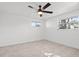 Bedroom showcasing tile floors, ceiling fan, and natural light at 1499 Janet Pl, Englewood, FL 34223