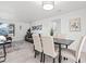 Bright dining room with seating for four, neutral colors, tile floors and modern decor at 1499 Janet Pl, Englewood, FL 34223