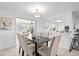 Cozy dining area with table seating for six, views of the kitchen, and modern lighting at 1499 Janet Pl, Englewood, FL 34223