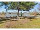 Charming single-story home boasts a pristine white exterior, complemented by a well-kept lawn and mature trees at 1499 Janet Pl, Englewood, FL 34223