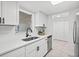 Bright kitchen with white cabinets, stainless steel appliances, and an undermount sink at 1499 Janet Pl, Englewood, FL 34223