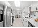 Spacious kitchen with white cabinetry, stainless appliances, and an undermount kitchen sink at 1499 Janet Pl, Englewood, FL 34223
