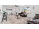 Spacious living room with large windows, comfortable seating, and contemporary decor exudes comfort and style at 1499 Janet Pl, Englewood, FL 34223