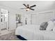 Elegant main bedroom with plush bedding, bright windows, and ensuite bathroom access at 1499 Janet Pl, Englewood, FL 34223