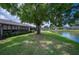 Beautiful backyard view with a serene pond and mature trees at 150 James Ct, Oldsmar, FL 34677
