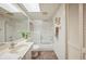 Well-lit bathroom features a shower-tub combo and updated fixtures at 150 James Ct, Oldsmar, FL 34677
