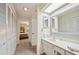 Bright bathroom with white vanity, mirrored cabinets, and view into bedroom at 150 James Ct, Oldsmar, FL 34677