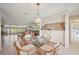 Dining area featuring a glass table, wicker chairs, and view into the living room at 150 James Ct, Oldsmar, FL 34677