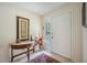 Bright foyer with tile flooring, a decorative table, and a storm door for added security at 150 James Ct, Oldsmar, FL 34677