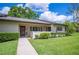 Charming single-story villa with a well-manicured lawn, sidewalk and white picket fence at 150 James Ct, Oldsmar, FL 34677