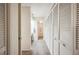 Hallway with linen closets leading to a bathroom, providing ample storage and convenience at 150 James Ct, Oldsmar, FL 34677