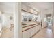 Bright kitchen featuring white cabinets, a breakfast bar, and an open layout perfect for entertaining at 150 James Ct, Oldsmar, FL 34677