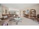 Cozy living area with tile flooring, comfortable seating, and access to the dining room at 150 James Ct, Oldsmar, FL 34677