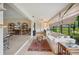 Bright sunroom with tile flooring, comfortable seating, and tranquil lake views at 150 James Ct, Oldsmar, FL 34677