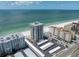Beautiful aerial view of beachfront condos with a pool, highlighting the building's location and ocean views at 17408 Gulf Blvd # 1302, Redington Shores, FL 33708