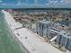 Stunning aerial view of beachfront condo complex and beautiful coastline, near pristine sandy beach on a sunny day at 17408 Gulf Blvd # 1302, Redington Shores, FL 33708