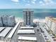 Stunning aerial view of beachfront condos, showcasing the building's proximity to the ocean and its parking areas at 17408 Gulf Blvd # 1302, Redington Shores, FL 33708