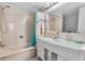 Modern bathroom with a glass vanity, soaking tub, and a shower at 17408 Gulf Blvd # 1302, Redington Shores, FL 33708