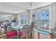 Bright dining room with ocean views, featuring a modern table and access to the balcony for outdoor enjoyment at 17408 Gulf Blvd # 1302, Redington Shores, FL 33708