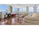 Bright living room filled with windows and water views, featuring comfortable seating and stylish decor at 17408 Gulf Blvd # 1302, Redington Shores, FL 33708
