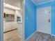 Bright kitchen featuring white cabinetry, granite counters, and wood-look flooring at 200 Glennes Ln # 205, Dunedin, FL 34698