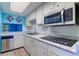 Modern kitchen with stainless steel appliances and bright blue wall at 200 Glennes Ln # 205, Dunedin, FL 34698