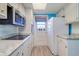 Bright kitchen featuring white appliances, modern oven, and a bright window at 200 Glennes Ln # 205, Dunedin, FL 34698