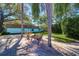 Beautiful landscaping of the exterior with palm trees, a sitting bench and a circular garden at 200 Glennes Ln # 205, Dunedin, FL 34698