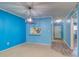 Open-concept living room with a pass-through to the kitchen and an adjacent hallway at 200 Glennes Ln # 205, Dunedin, FL 34698