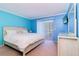 Inviting bedroom with sliding glass doors leading to an outdoor balcony at 200 Glennes Ln # 205, Dunedin, FL 34698