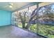 Enjoy the view of mature trees and landscaping from this enclosed porch at 200 Glennes Ln # 205, Dunedin, FL 34698