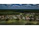An aerial view highlights lakefront homes with sparkling pools near a lush green golf course at 2042 Diamond Ct, Oldsmar, FL 34677