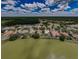 An aerial shot capturing homes nestled by a lake and golf course, surrounded by mature trees at 2042 Diamond Ct, Oldsmar, FL 34677