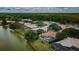 An aerial view features lakeside homes with screened pools surrounded by lush landscaping at 2042 Diamond Ct, Oldsmar, FL 34677