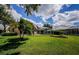 Lush backyard featuring a screened in pool and patio area for outdoor enjoyment at 2042 Diamond Ct, Oldsmar, FL 34677