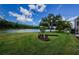 Expansive backyard with manicured lawn and scenic lake views at 2042 Diamond Ct, Oldsmar, FL 34677