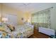 Bright bedroom with a ceiling fan, closet, and floral curtains at 2042 Diamond Ct, Oldsmar, FL 34677