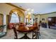 Dining room with large table, elegant chandelier, and arched doorway to foyer at 2042 Diamond Ct, Oldsmar, FL 34677
