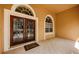 Elegant glass front doors with arched windows and tiled porch at 2042 Diamond Ct, Oldsmar, FL 34677