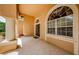 Spacious tiled front porch with columns, arched window, and double door entrance at 2042 Diamond Ct, Oldsmar, FL 34677