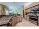 Gourmet kitchen with granite countertops, stainless appliances, and a stylish tile backsplash at 2042 Diamond Ct, Oldsmar, FL 34677