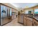 Spacious kitchen features stainless steel refrigerator, granite counters, and ample cabinetry at 2042 Diamond Ct, Oldsmar, FL 34677
