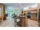Bright kitchen with granite counters, stainless steel appliances, and breakfast bar seating at 2042 Diamond Ct, Oldsmar, FL 34677