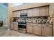A kitchen view showcases the cabinets, countertops, tile backsplash, and stainless steel oven at 2042 Diamond Ct, Oldsmar, FL 34677